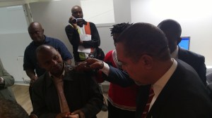 A passport officer at the embassy showing Amb Amobi how the machine works